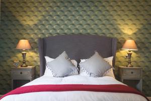 a bedroom with a large bed with two lamps at The Townhouse in Stratford-upon-Avon