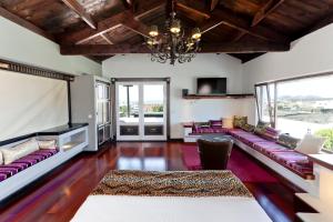 a living room with purple couches and a chandelier at Casa de Hilario in Yaiza