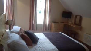 Tempat tidur dalam kamar di Ashfield B&B