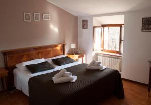 Postel nebo postele na pokoji v ubytování Boutique Hotel Corte Malaspina