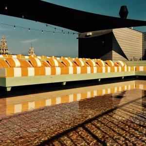 a row of orange and white seats on a platform at Wittmore Hotel - Adults Only in Barcelona