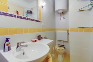 a bathroom with a sink and a toilet at Apartment Neno in Veli Lošinj