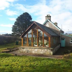 a glass extension to a house at Auchencairn Cottage in Brora