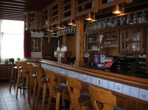 a bar with a row of wooden bar stools at Keglerbörse "Haus Ida" in Kleve