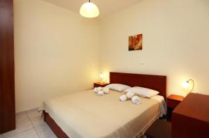 Postel nebo postele na pokoji v ubytování Olivera Apartments