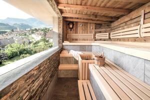 an outdoor sauna with benches and a view at Das Panorama Dependance in Caldaro