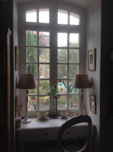 a window in a room with two lamps on a table at Le petit Figuier in La Roque-dʼAnthéron +49 photos