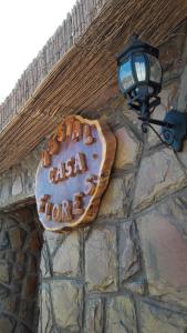 a sign on the side of a building with a sign at Hostal Casa Flores in San Pedro de Atacama