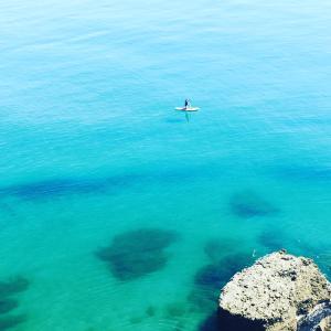 a person in a boat in the water at Axarquia Apartments in Nerja