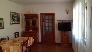 a room with a television and a table and a door at Sole&Luna in San Teodoro