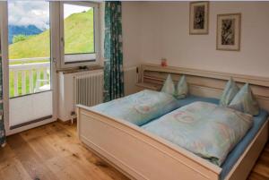 a bedroom with a bed in a room with a window at Ferienwohnung Zwoelferblick in Bramberg am Wildkogel