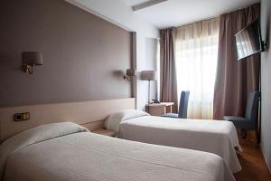 Postel nebo postele na pokoji v ubytování Hotel Brial