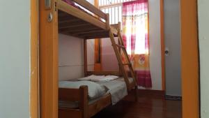 A bed or beds in a room at Casaoro Homestay