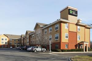 a building with cars parked in a parking lot at Extended Stay America Suites - Long Island - Melville in Melville