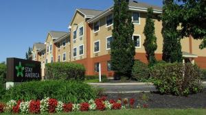 a building with a sign and flowers in front of it at Extended Stay America Suites - Philadelphia - Mt Laurel - Crawford Place in Mount Laurel
