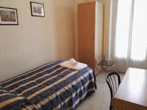 Postel nebo postele na pokoji v ubytování Hotel Loreto