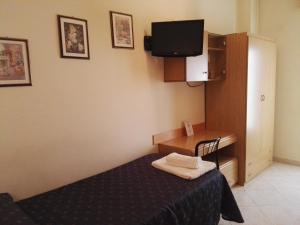 Postel nebo postele na pokoji v ubytování Hotel Loreto