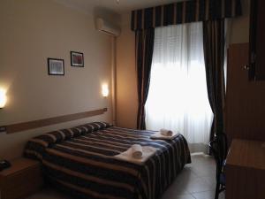 Postel nebo postele na pokoji v ubytování Hotel Loreto