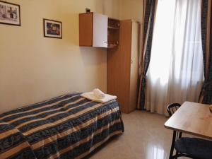 Postel nebo postele na pokoji v ubytování Hotel Loreto