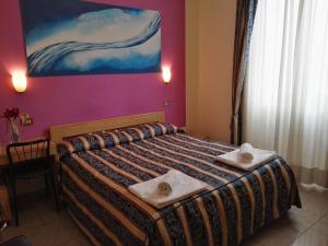 Postel nebo postele na pokoji v ubytování Hotel Loreto