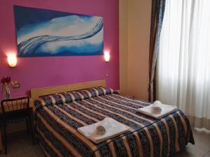 Postel nebo postele na pokoji v ubytování Hotel Loreto