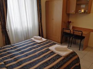 Postel nebo postele na pokoji v ubytování Hotel Loreto