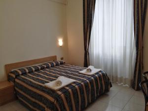 Postel nebo postele na pokoji v ubytování Hotel Loreto