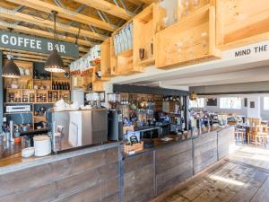a coffee bar with wooden cabinets and a counter at The Sail Loft in Southwold