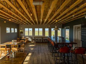 a restaurant with tables and chairs in a room at The Sail Loft in Southwold