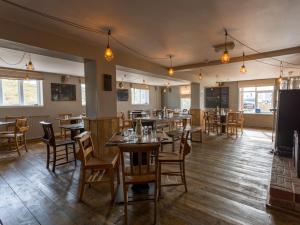 a dining room with wooden tables and chairs at The Sail Loft in Southwold