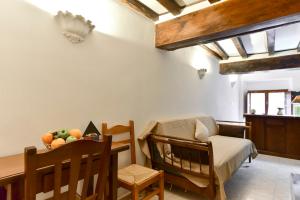 a bedroom with a crib and a table with a chair at Loft Pantheon in Rome