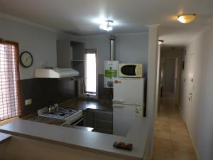 een keuken met een witte koelkast en een fornuis bij Departamentos Córdoba Nuevo Kaiken in Cordoba
