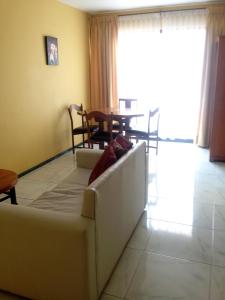 a living room with a couch and a table at Apart Hotel Astore in Antofagasta