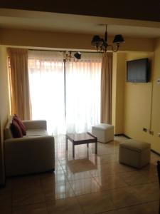 a living room with a couch and a table at Apart Hotel Astore in Antofagasta