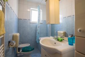 a bathroom with a sink and a toilet at Guest House Croatia in Fažana +51 photos