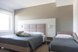 A bed or beds in a room at Albergo Ristorante Belvedere