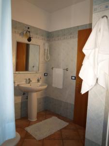 La salle de bains est pourvue d'un lavabo et d'un miroir. dans l'établissement Sun Garden, à San Vito Lo Capo