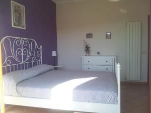 a bedroom with a white bed and a dresser at Good Morning Etna in Bronte