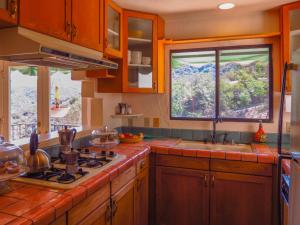 a kitchen with a stove top oven next to a window at Topanga Canyon Inn Bed and Breakfast in Topanga