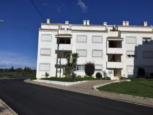 a white building on the side of a street at Cabanas de Tavira Apartment in Cabanas de Tavira