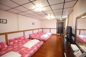 Postel nebo postele na pokoji v ubytování First Place B&B (Hualien Railway Station)