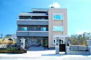 a large building with a gate in front of it at Taitung XD B&B in Taitung City