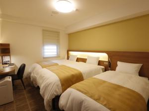 Postel nebo postele na pokoji v ubytování Hotel Sunroute Sopra Kobe Annesso