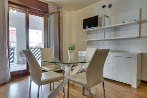 a dining room with a glass table and chairs at Quartiere Padova 2000 in Padova