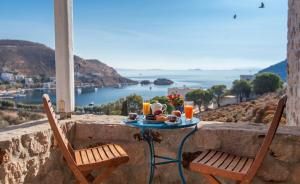 a table with food and drinks on top of a wall at Theologos Houses in Grikos