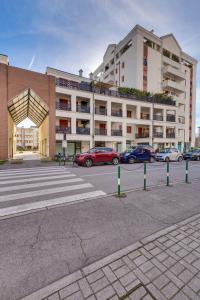 a parking lot with cars parked in front of a building at Quartiere Padova 2000 in Padova