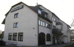 un bâtiment blanc avec un panneau sur son côté dans l'établissement Hotel Kelkheimer Hof, à Kelkheim