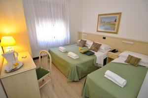 Postel nebo postele na pokoji v ubytování Hotel San Giuliano