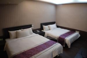 Postel nebo postele na pokoji v ubytování King Town Hotel