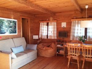 a living room with a couch and a table at Cabana de Santo António in Vila Nova de Cerveira